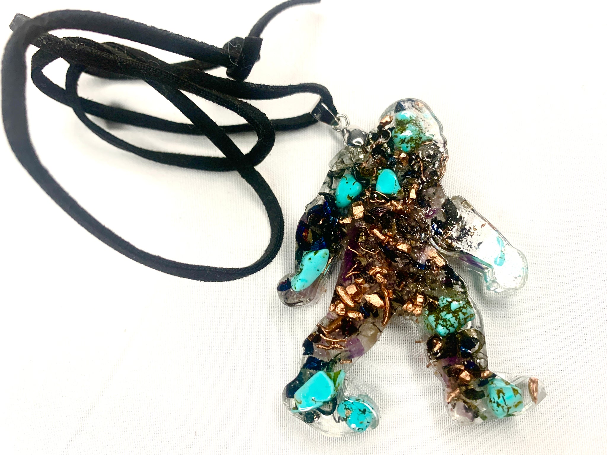 hand made orgone bigfoot pendant with quartz crystals and turquoise